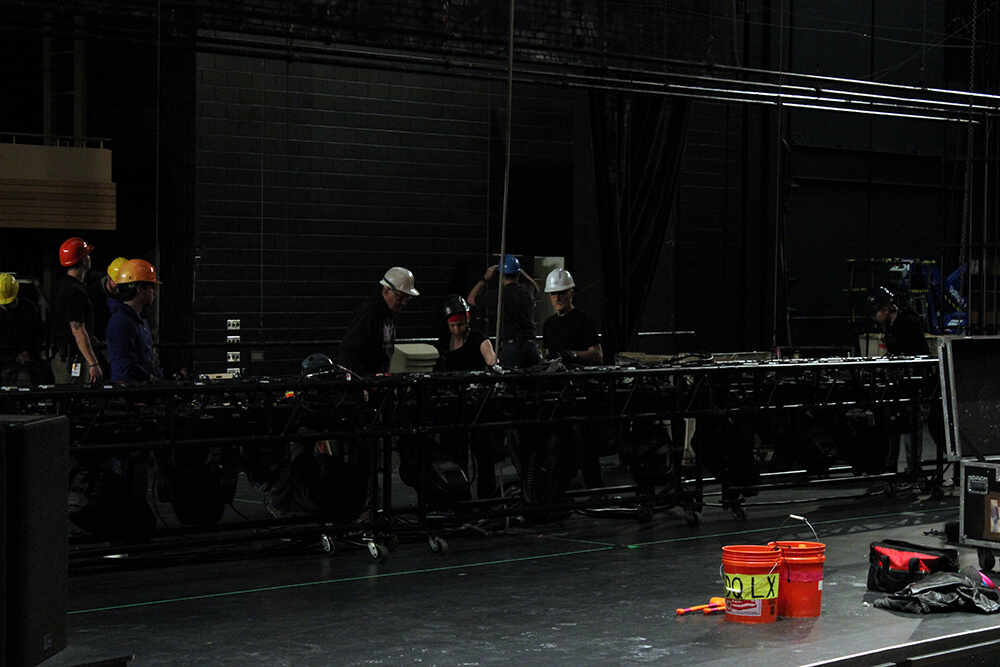 Crew working on the lighting rig for Million Dollar Quartet.